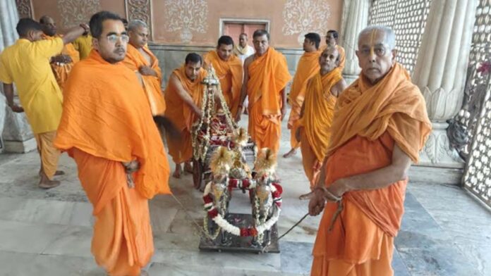 Thakur ji was seated on a silver stool