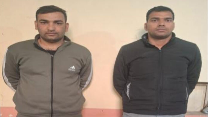 A constable and a driver deployed in a police vehicle have been arrested on charges of robbery.