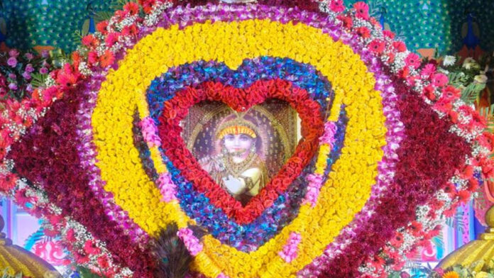 Lord Shyam is seated on a kite made of flowers.