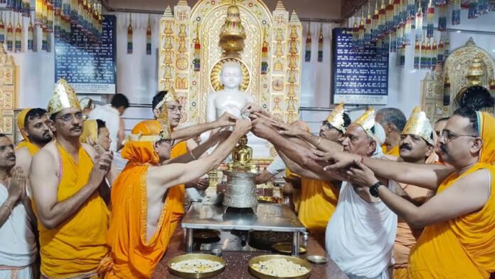 Grand anointing ceremony held for the Jina idols enshrined on the spires of the Digambar Jain temple. Grand anointing ceremony held for the Jina idols enshrined on the spires of the Digambar Jain temple.